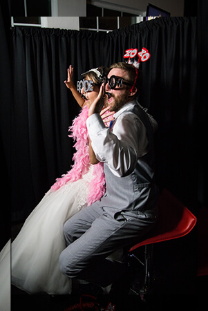 wedding couple taking pictures at the manor at coffee creek photo booth