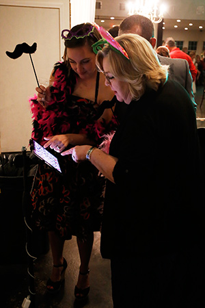 photo booth clients at ipad and hashtag printing station at venue in edmond, oklahoma