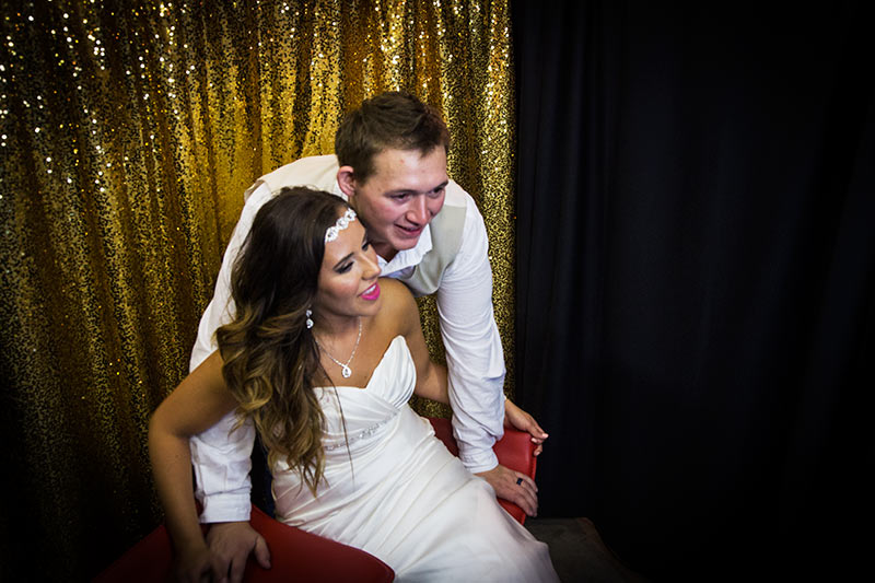 enclosed photo booth at wedding reception with elegant sequin gold backdrop in oklahoma city, oklahoma