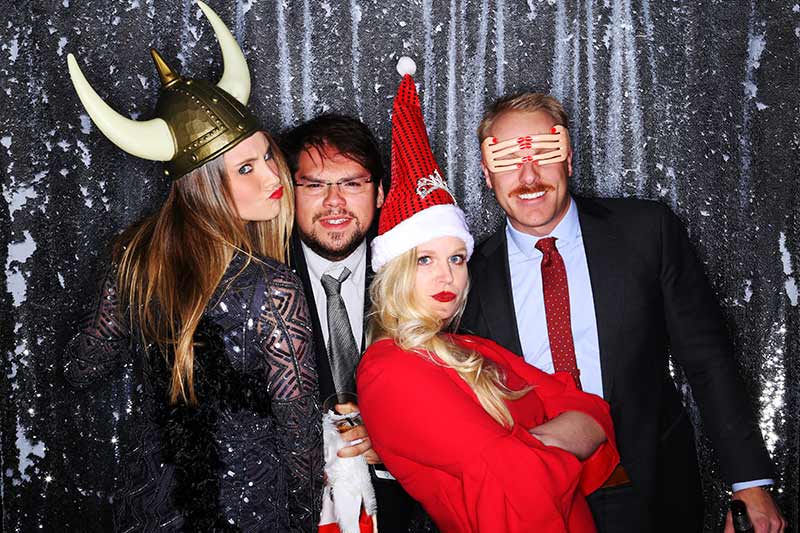 mark_west_800px a photobooth picture of a girl posing in a santa hat with friends