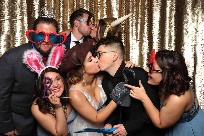 open air photo booth set up ready for wedding, with scrapbook, props, signs, printer, camera and lighting at the 11 oaks ranch venue in luther, oklahoma