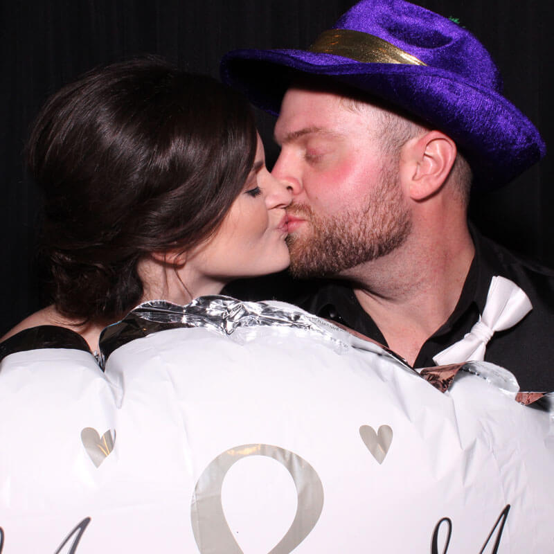 first_snapmecrazy_wedding photo booth attendant laughing with guests as they have their pictures snapped in our snap me crazy photobooth in edmond, oklahoma.