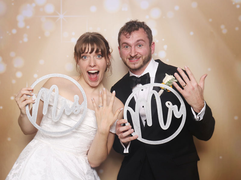 just_married Ladies pose like models inside a photo booth in downtown OKC.