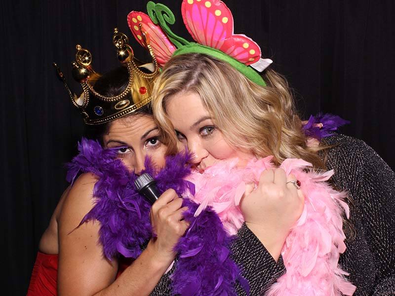 ladies_animated_pose photo booth attendant laughing with guests as they have their pictures snapped in our snap me crazy photobooth in edmond, oklahoma.