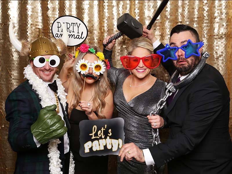 lets_party photo booth attendant laughing with guests as they have their pictures snapped in our snap me crazy photobooth in edmond, oklahoma.