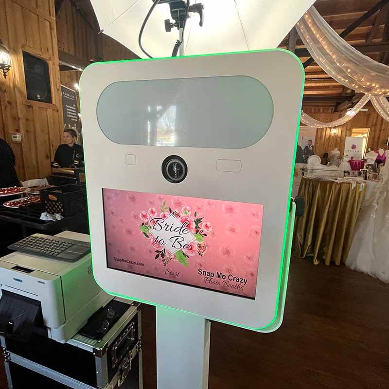 studio_photobooth Snap Me Crazy Photo Booths at an event. A touchscreen monitor with wedding graphics are shown on the screen that says "Bride To Be"