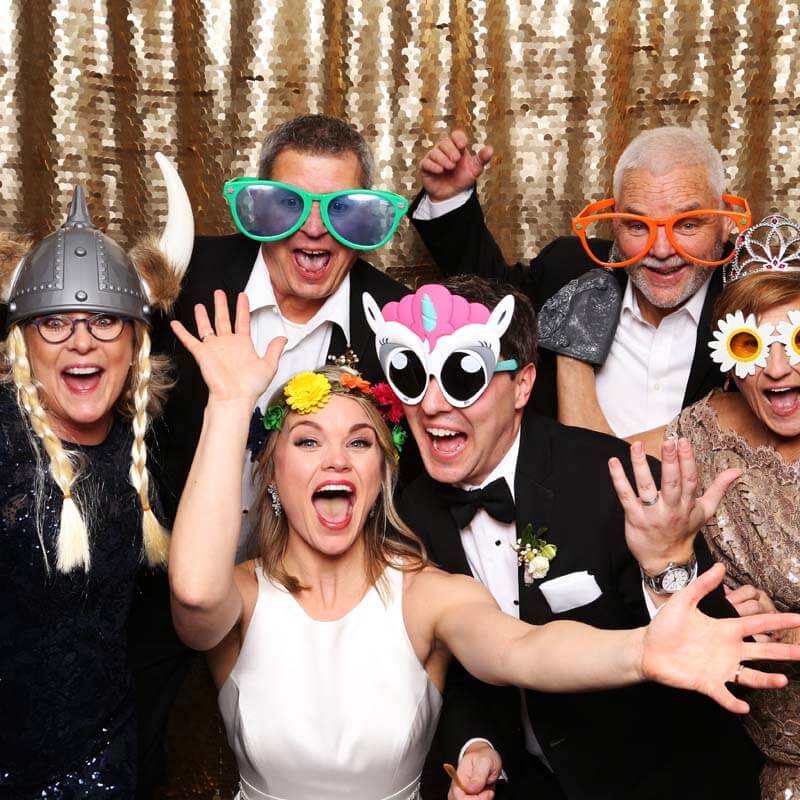 Excited Bride at Wedding Booth A group of wedding party goers surround a bride who is having lots of fun!